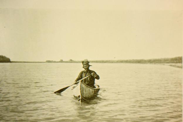 Cree man Simon Bell in canoe on Saskatchewan River at The Pas